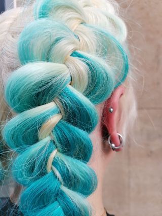 “Cool-toned braided perfection: a seamless blend of icy platinum and turquoise hues, creating dimension and movement...